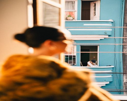 Person looking out of a window in a sunny Mexico City apartment