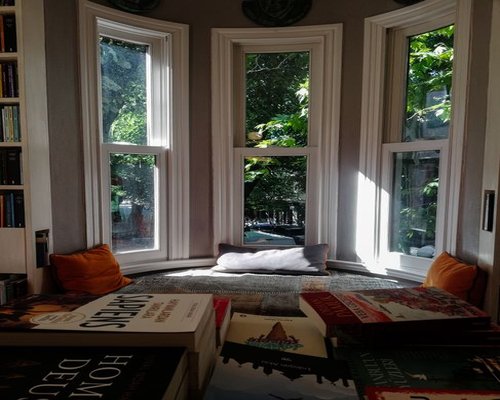 Cozy reading nook with natural sunlight streaming through a window in a contemporary home