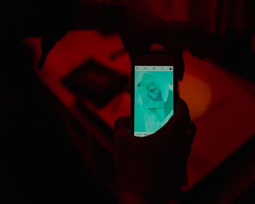 Close up of a smartphone screen with warm color filter applied at night